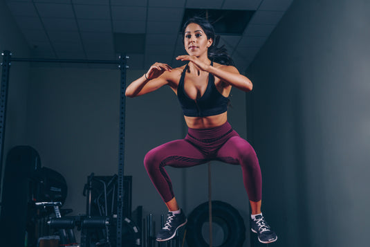 Woman jumping in workout clothes